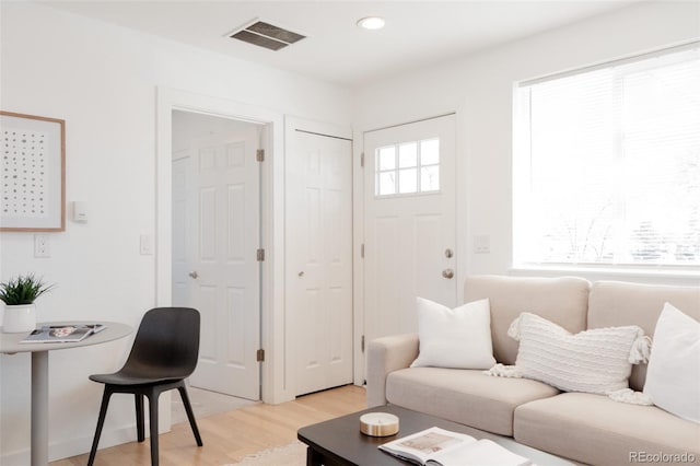 living room featuring recessed lighting, visible vents, and light wood finished floors