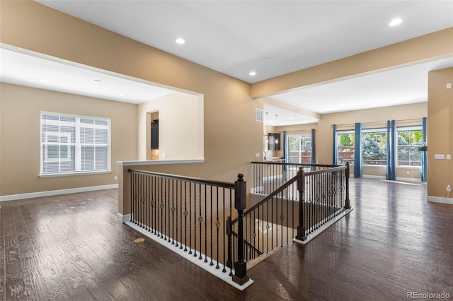 10122 Des Moines St, Parker, CO 80134 - hall featuring an upstairs landing, wood finished floors, and recessed lighting