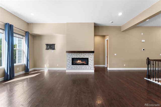 10122 Des Moines St, Parker, CO 80134 - unfurnished living room featuring wood finished floors, a tiled fireplace, and recessed lighting