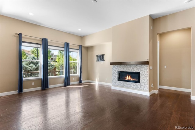 10122 Des Moines St, Parker, CO 80134 - unfurnished living room with wood finished floors, a glass covered fireplace, and recessed lighting