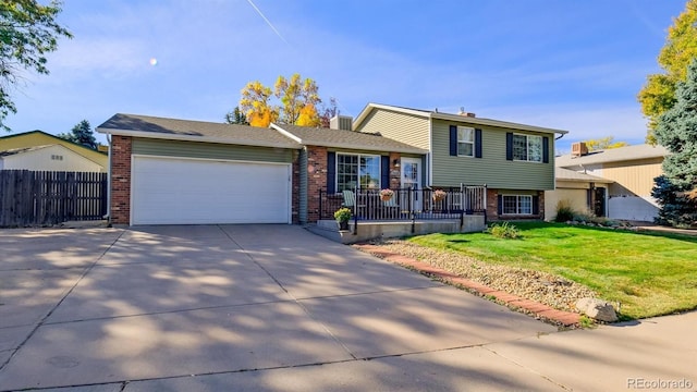 split level home with a front yard and a garage