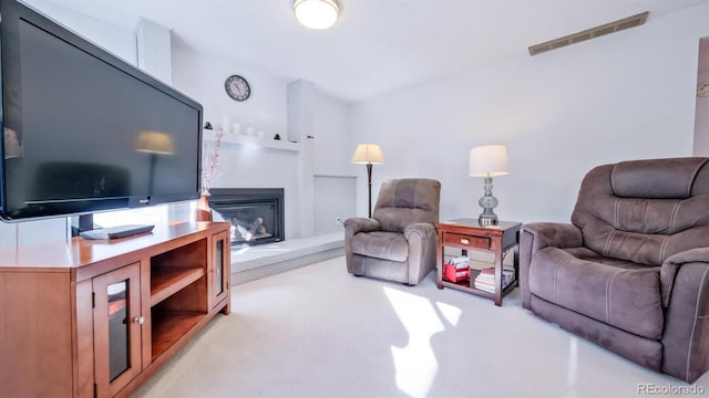 living room featuring a large fireplace