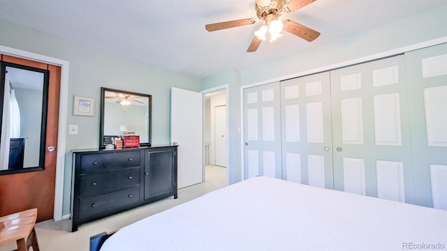 carpeted bedroom with a textured ceiling and ceiling fan