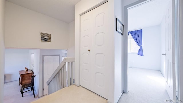 corridor with light colored carpet