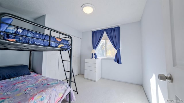 carpeted bedroom featuring a textured ceiling