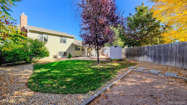 view of yard featuring a shed and a patio