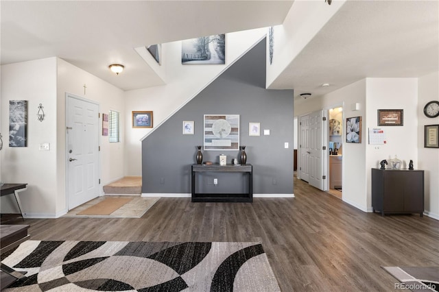 foyer entrance with baseboards and wood finished floors