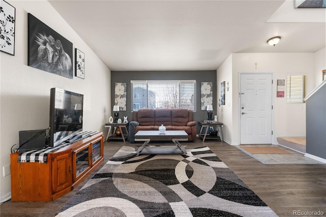 living room with baseboards and wood finished floors