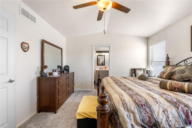 bedroom featuring baseboards, visible vents, connected bathroom, light colored carpet, and vaulted ceiling