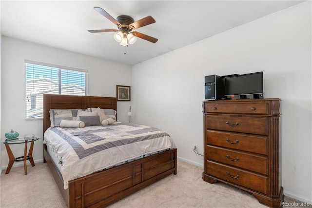 bedroom with baseboards, a ceiling fan, and light colored carpet