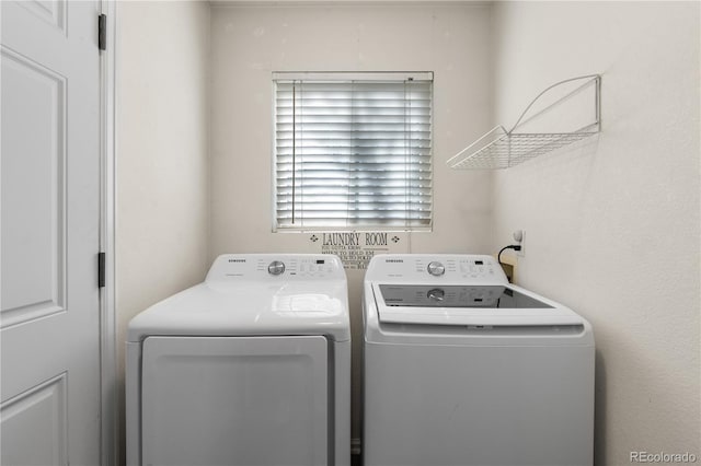 clothes washing area featuring laundry area and washer and clothes dryer