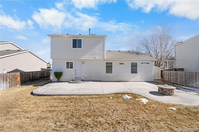 rear view of house with a yard, an outdoor fire pit, a patio area, and a fenced backyard