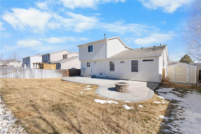 back of property with a storage shed, a lawn, an outbuilding, fence, and a patio area