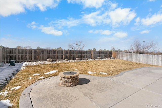 view of yard with a fenced backyard, a fire pit, and a patio