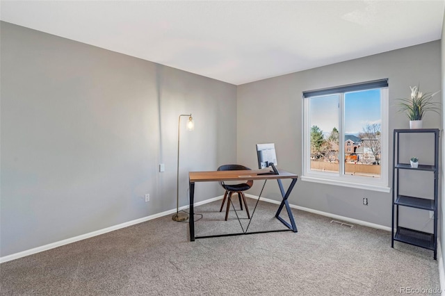 carpeted office space with visible vents and baseboards