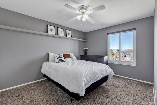 carpeted bedroom with ceiling fan, visible vents, and baseboards