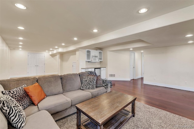 living area with recessed lighting, visible vents, dark wood finished floors, and baseboards