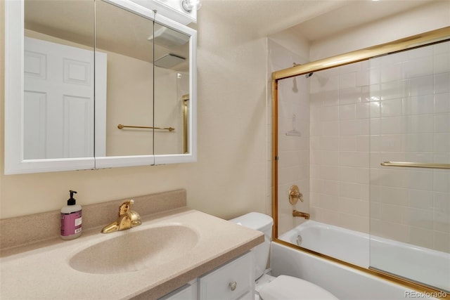 bathroom featuring shower / bath combination with glass door, vanity, and toilet