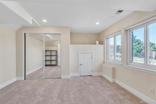 unfurnished bedroom featuring carpet floors, visible vents, and baseboards