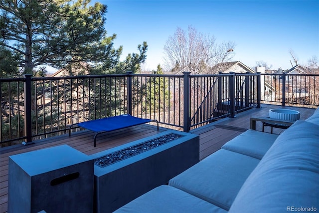 deck with an outdoor living space with a fire pit