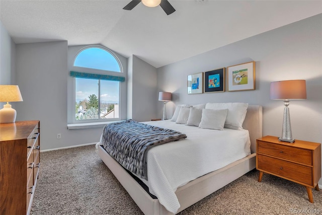 bedroom with baseboards, a ceiling fan, vaulted ceiling, and carpet flooring