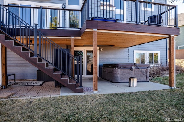 exterior space featuring stairway and a hot tub