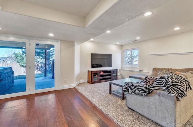 living area with recessed lighting, wood finished floors, and baseboards