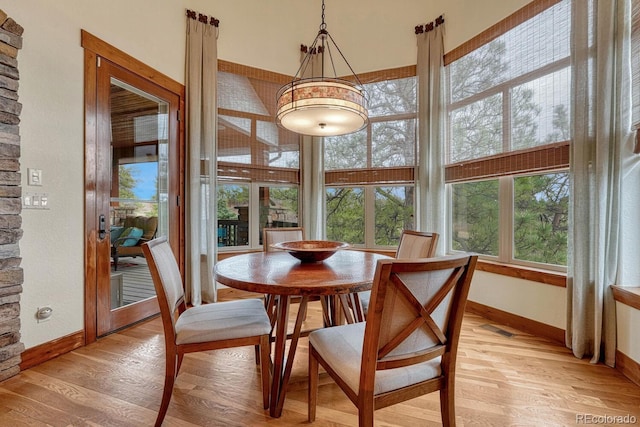 dining room with light wood-style flooring and baseboards