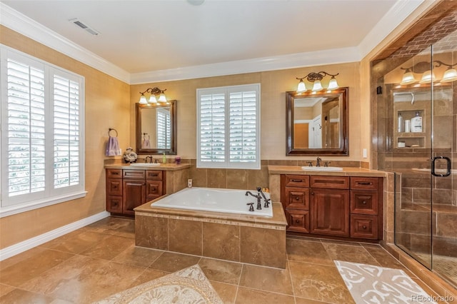 bathroom featuring visible vents, ornamental molding, a sink, a shower stall, and a garden tub