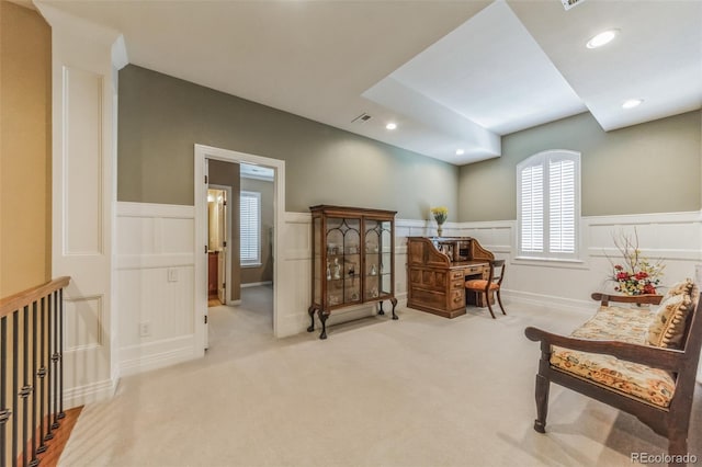 living area featuring recessed lighting, visible vents, wainscoting, and light colored carpet