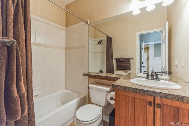 full bathroom featuring vanity, toilet, shower / bath combo with shower curtain, and wallpapered walls