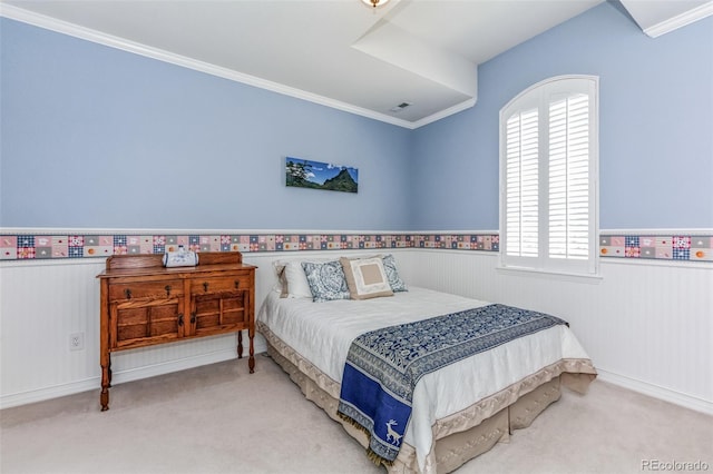 bedroom with a wainscoted wall, multiple windows, and carpet flooring