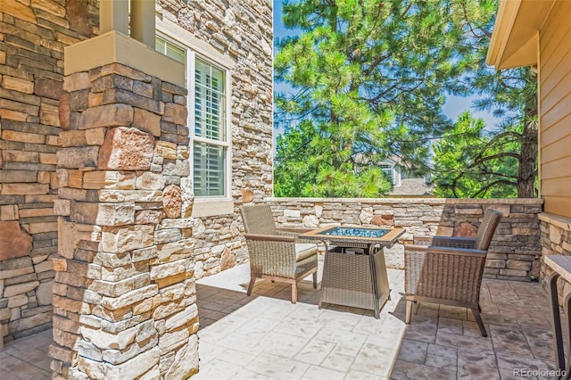 view of patio / terrace featuring an outdoor fire pit