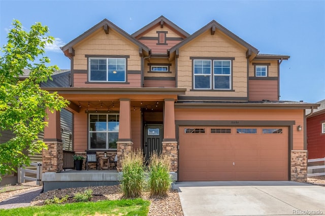 16694 Miners Way, Broomfield, CO 80023 - craftsman inspired home with covered porch, a garage, stone siding, and driveway