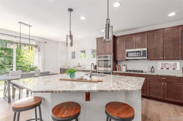 16694 Miners Way, Broomfield, CO 80023 - kitchen featuring stainless steel appliances, healthy amount of natural light, recessed lighting, light wood finished floors, and a breakfast bar