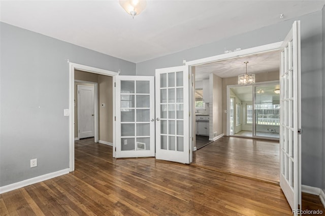 770 Havana St, Aurora, CO 80010 - spare room with french doors, a chandelier, hardwood / wood-style flooring, and baseboards