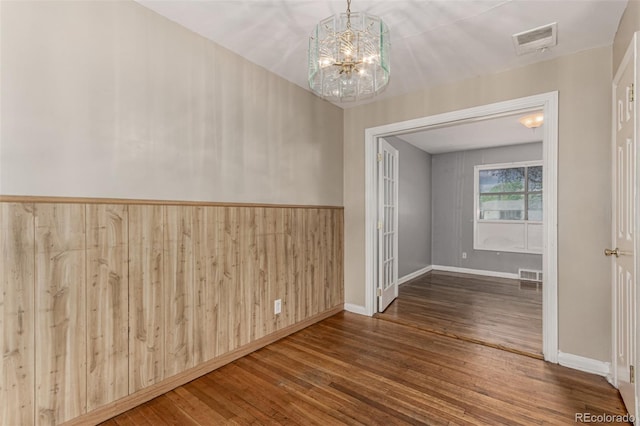 770 Havana St, Aurora, CO 80010 - empty room with wood-type flooring, a chandelier, and baseboards