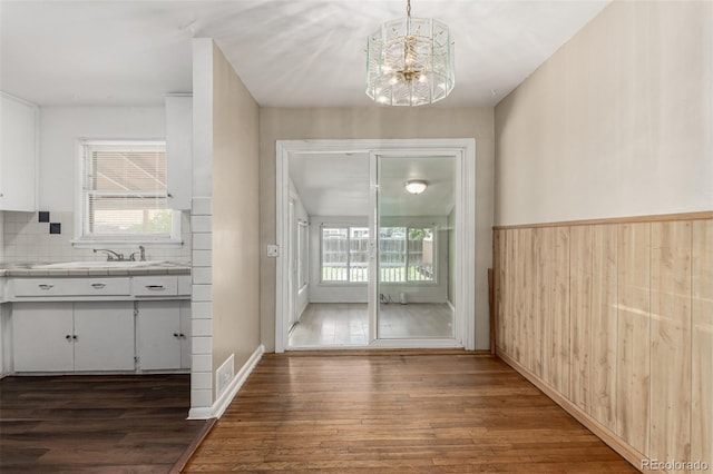 770 Havana St, Aurora, CO 80010 - unfurnished dining area with a chandelier, wood finished floors, plenty of natural light, and a sink