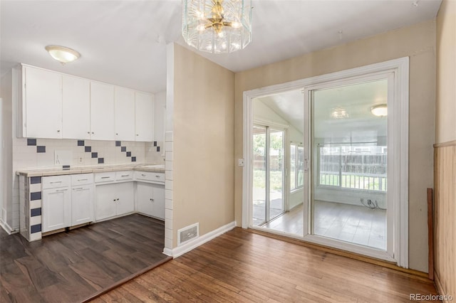 770 Havana St, Aurora, CO 80010 - kitchen featuring dark wood-style floors, baseboards, white cabinets, a chandelier, and light countertops