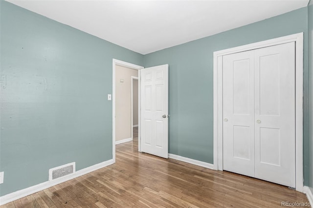 770 Havana St, Aurora, CO 80010 - unfurnished bedroom with wood finished floors, baseboards, and a closet