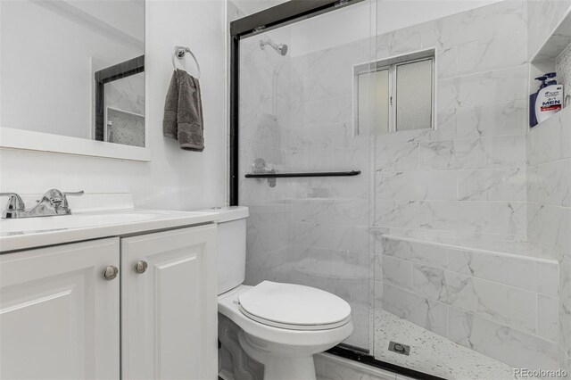 770 Havana St, Aurora, CO 80010 - bathroom featuring a stall shower, toilet, and vanity