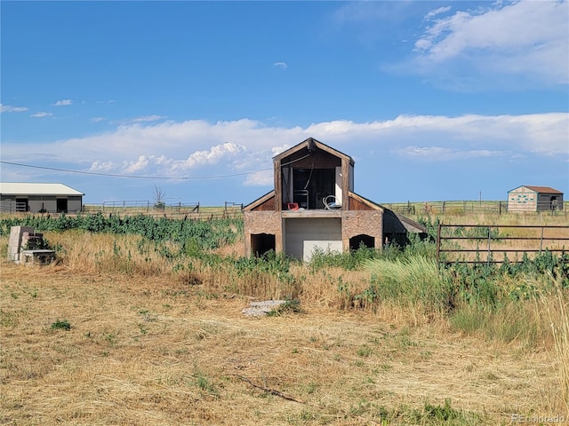 71777 E County Road 10, Byers, CO 80103 - view of yard with a barn, an outdoor structure, and a view of rural / pastoral area