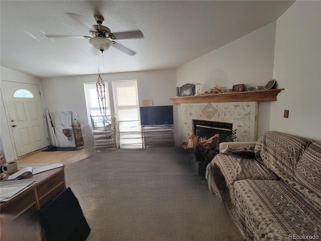 71777 E County Road 10, Byers, CO 80103 - living area with ceiling fan, plenty of natural light, carpet, a fireplace, and a textured ceiling
