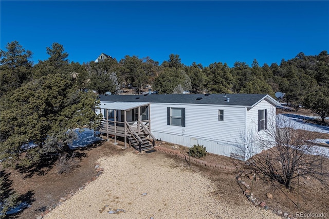 back of property with a wooden deck