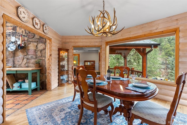 dining area featuring a chandelier and rustic walls