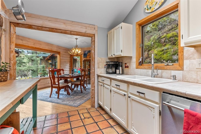 kitchen with dishwasher, a sink, a chandelier, and healthy amount of natural light