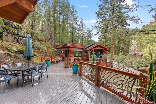 wooden deck featuring outdoor dining space