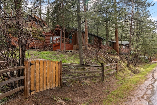 view of home's exterior featuring fence, a gate, and stairs