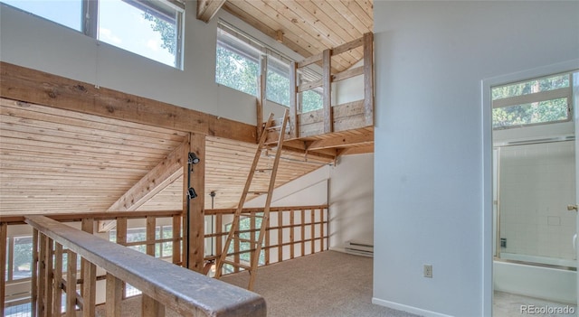 hall featuring wooden ceiling, baseboard heating, carpet flooring, high vaulted ceiling, and beam ceiling