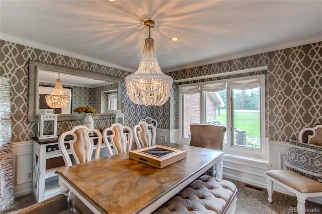 dining space with ornamental molding and a chandelier